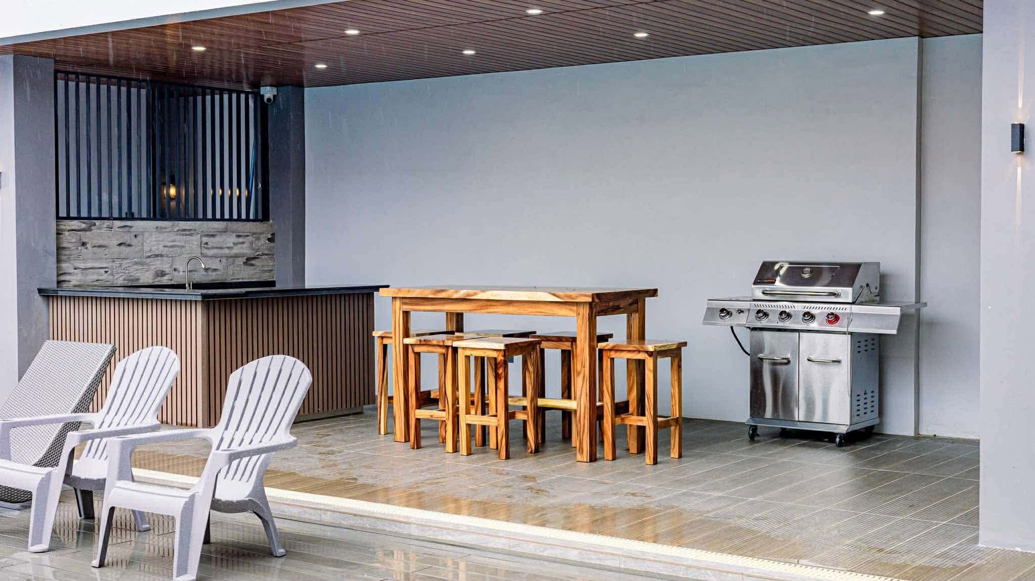 Covered dining area with grill and kitchen counter